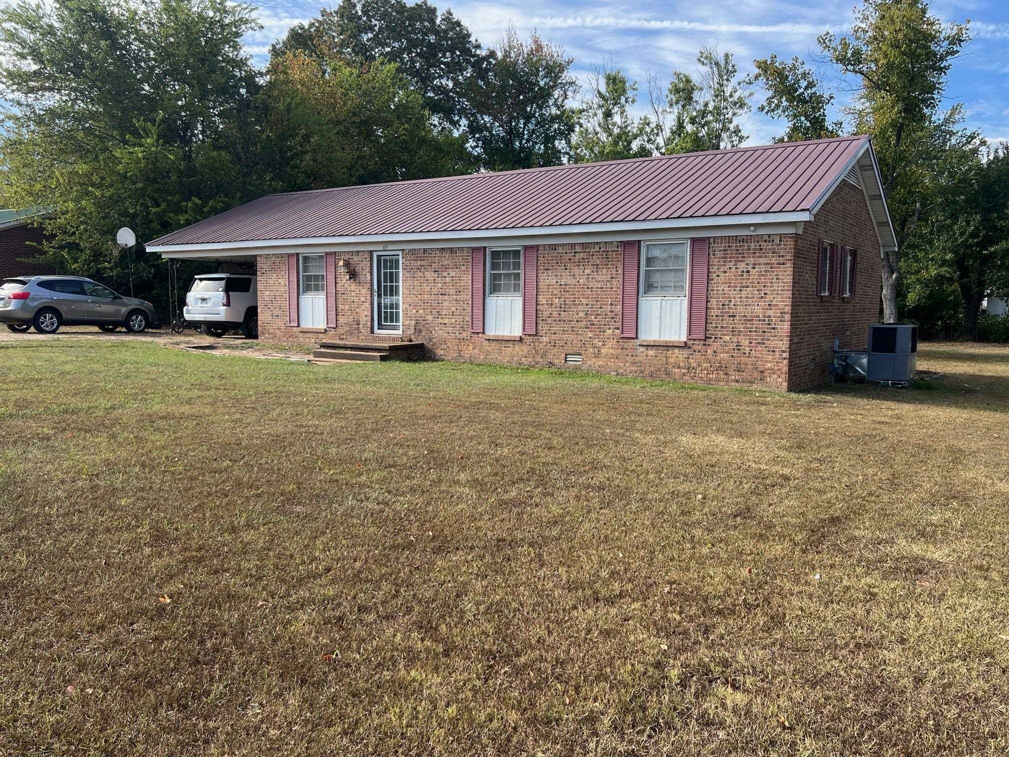 65 Walnut Street Savannah, TN 38372 - Photo 17 of 18 a front view of a house with a garden