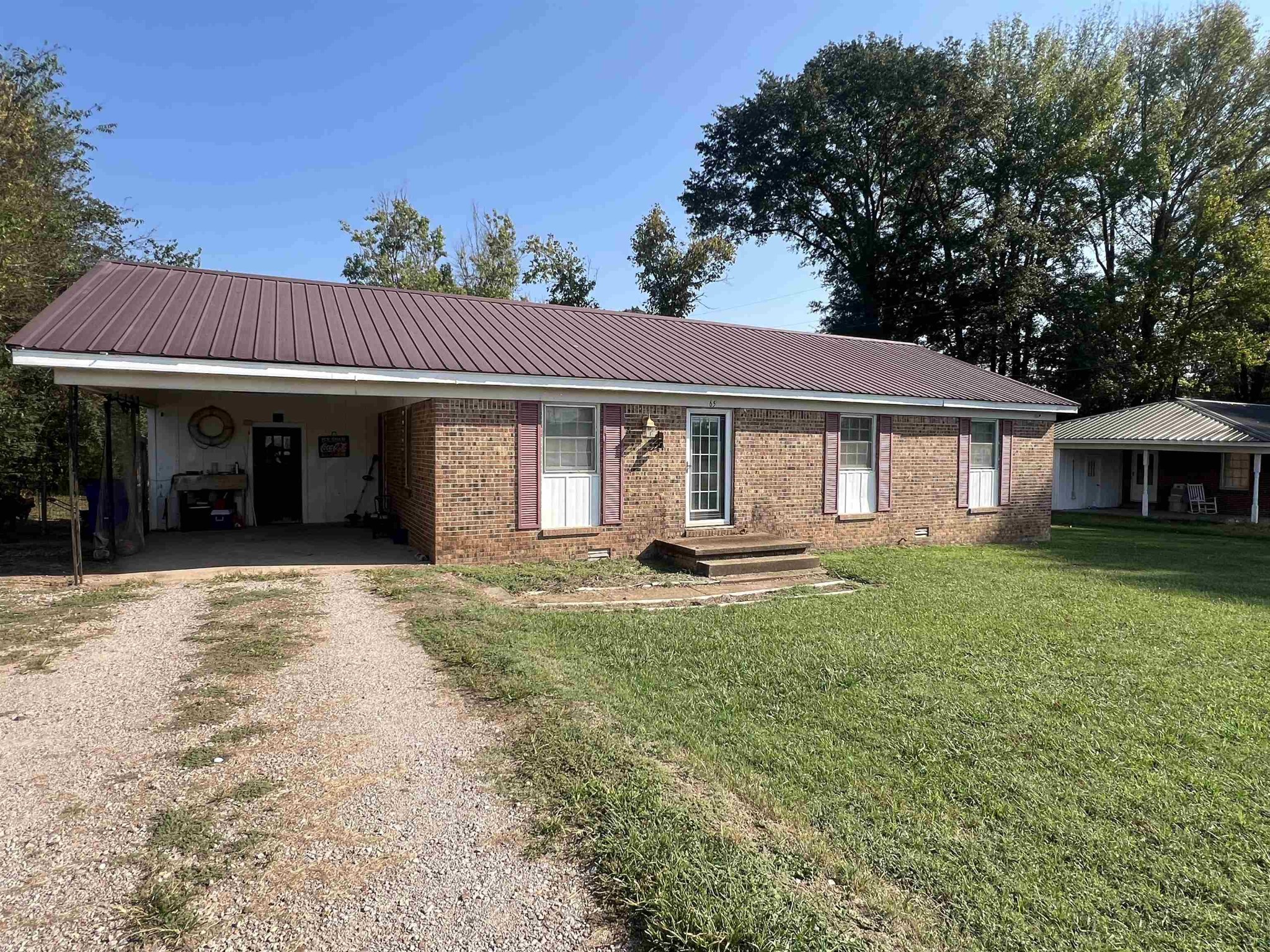 65 Walnut Street Savannah, TN 38372 - Photo 18 of 18 a front view of a house with a garden and porch