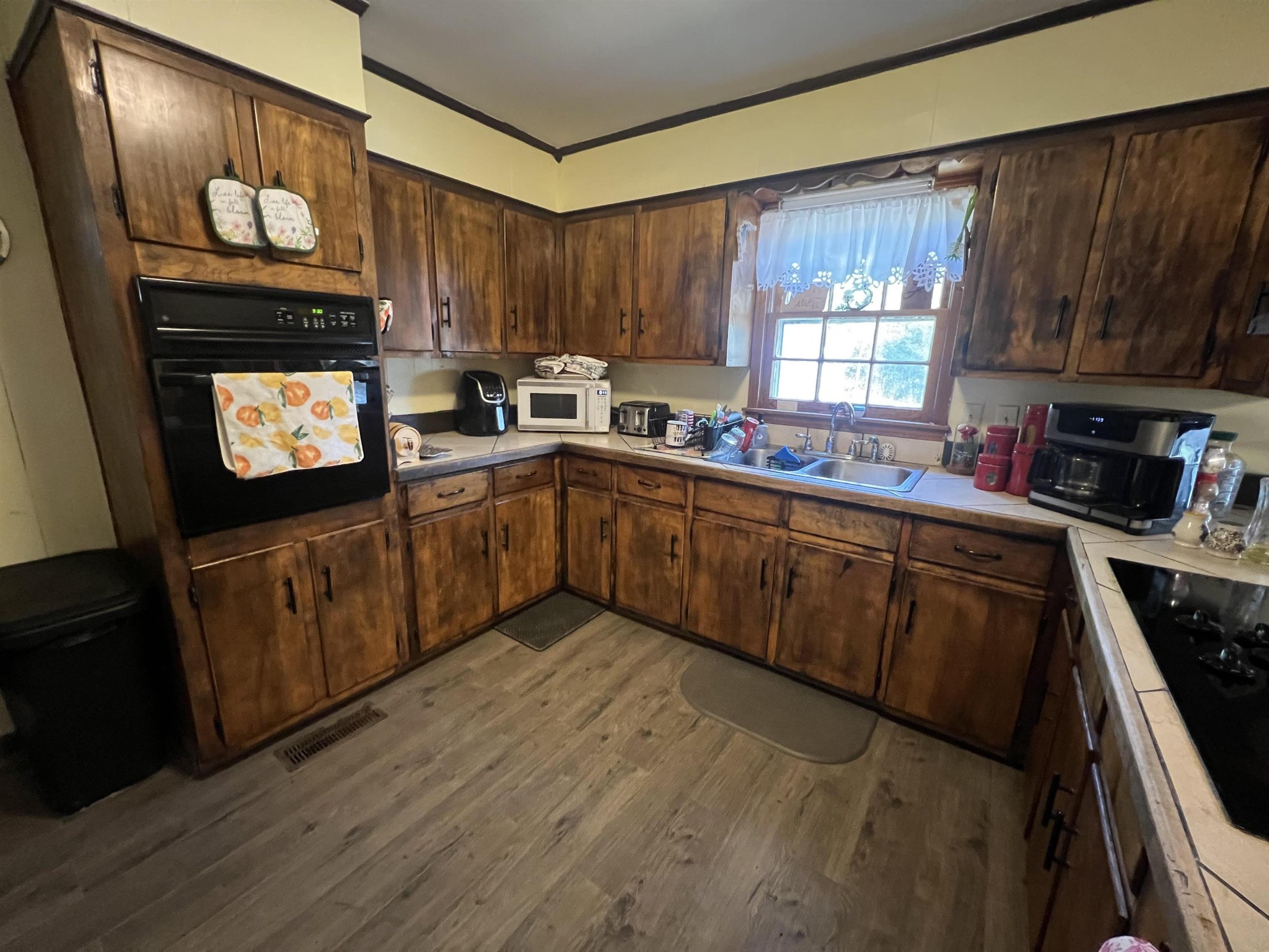 65 Walnut Street Savannah, TN 38372 - Photo 2 of 18 a kitchen with stainless steel appliances granite countertop a stove a sink dishwasher and a microwave oven with cabinets
