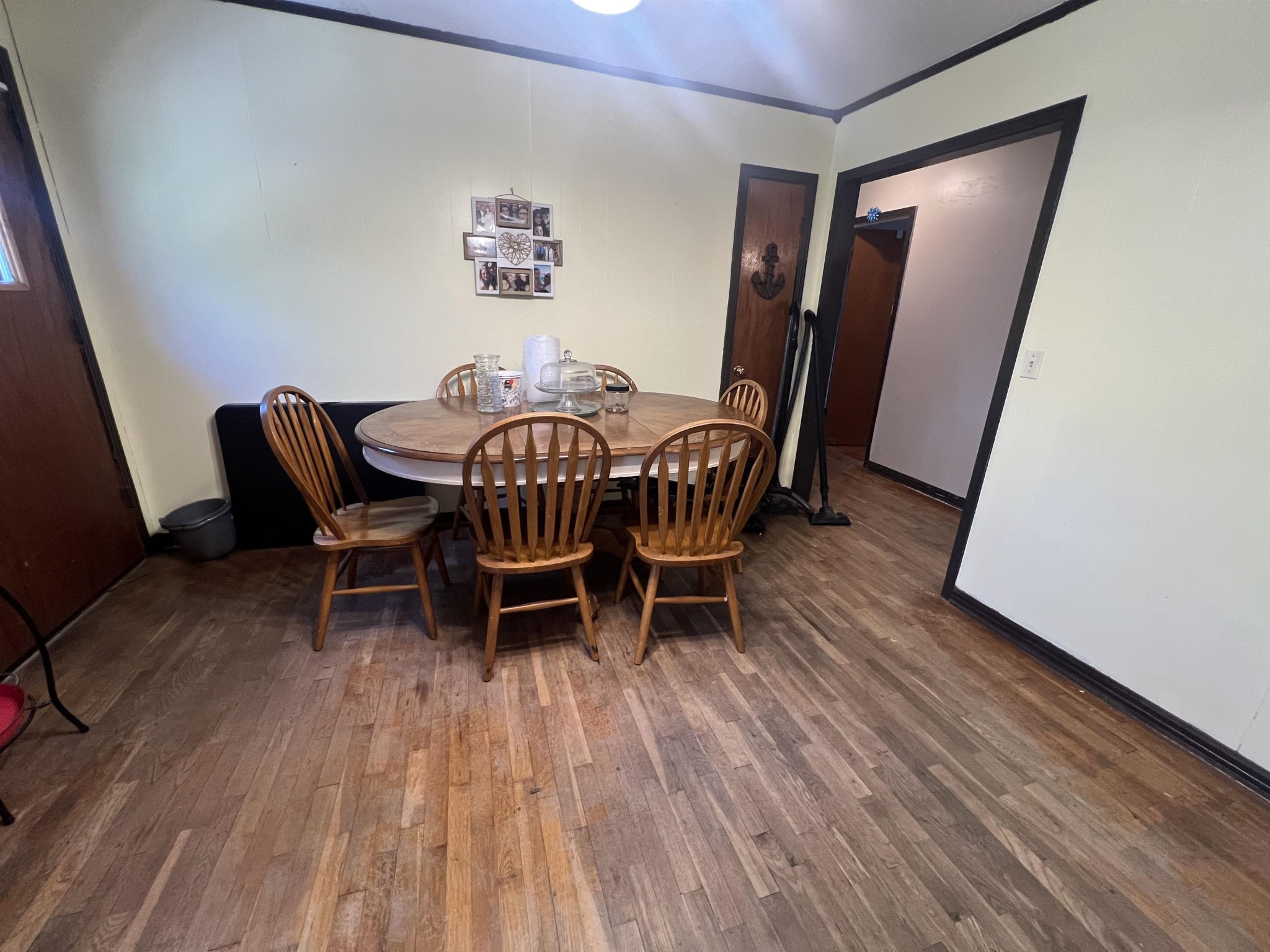 65 Walnut Street Savannah, TN 38372 - Photo 4 of 18 a view of a dining room with furniture and wooden floor