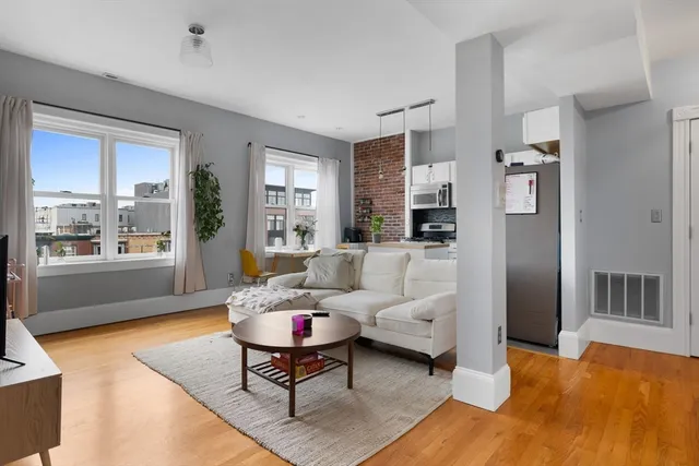 a living room with furniture wooden floor and a table