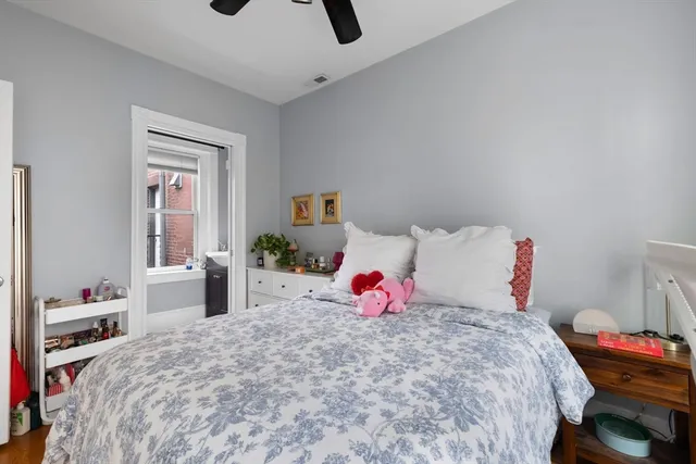 a bedroom with bed and a window