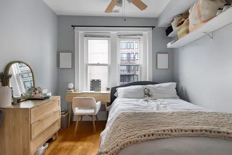 a bedroom with a bed and a dresser