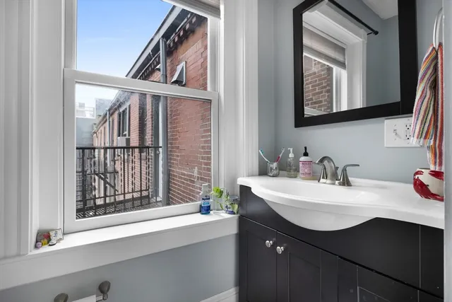 a bathroom with a sink vanity and a mirror