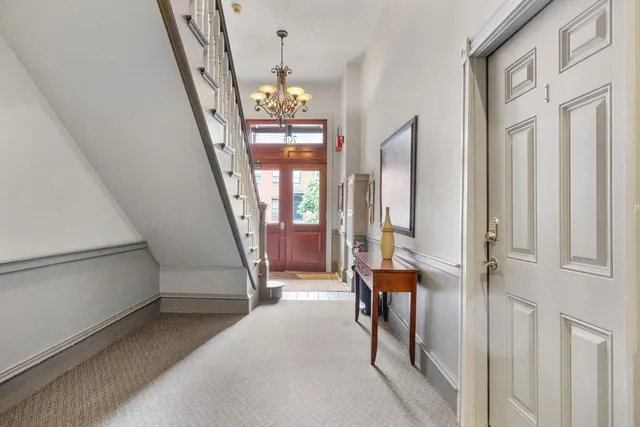 a view of an entryway with hardwood floor and livingroom