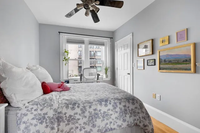 a bedroom with a large bed and a chandelier