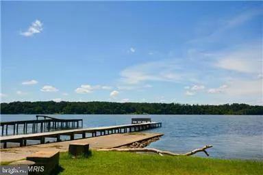 a view of a lake with houses in the back