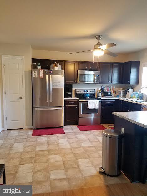 20 Sandy Lane Stafford, VA 22554 - Photo 4 of 15 a kitchen with stainless steel appliances granite countertop a refrigerator stove top oven and sink