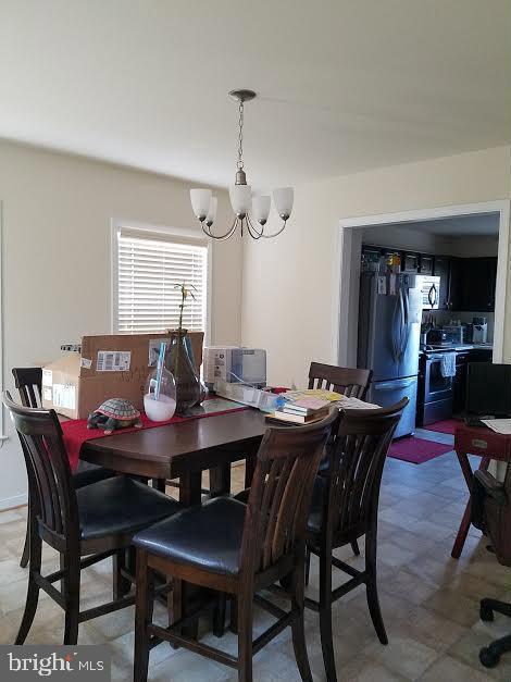 20 Sandy Lane Stafford, VA 22554 - Photo 5 of 15 a view of a dining room and livingroom furniture wooden table a rug and a chandelier