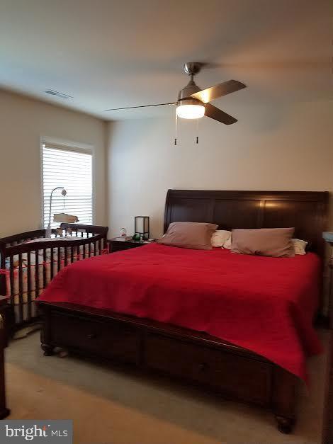 20 Sandy Lane Stafford, VA 22554 - Photo 6 of 15 a bedroom with a bed and a chandelier