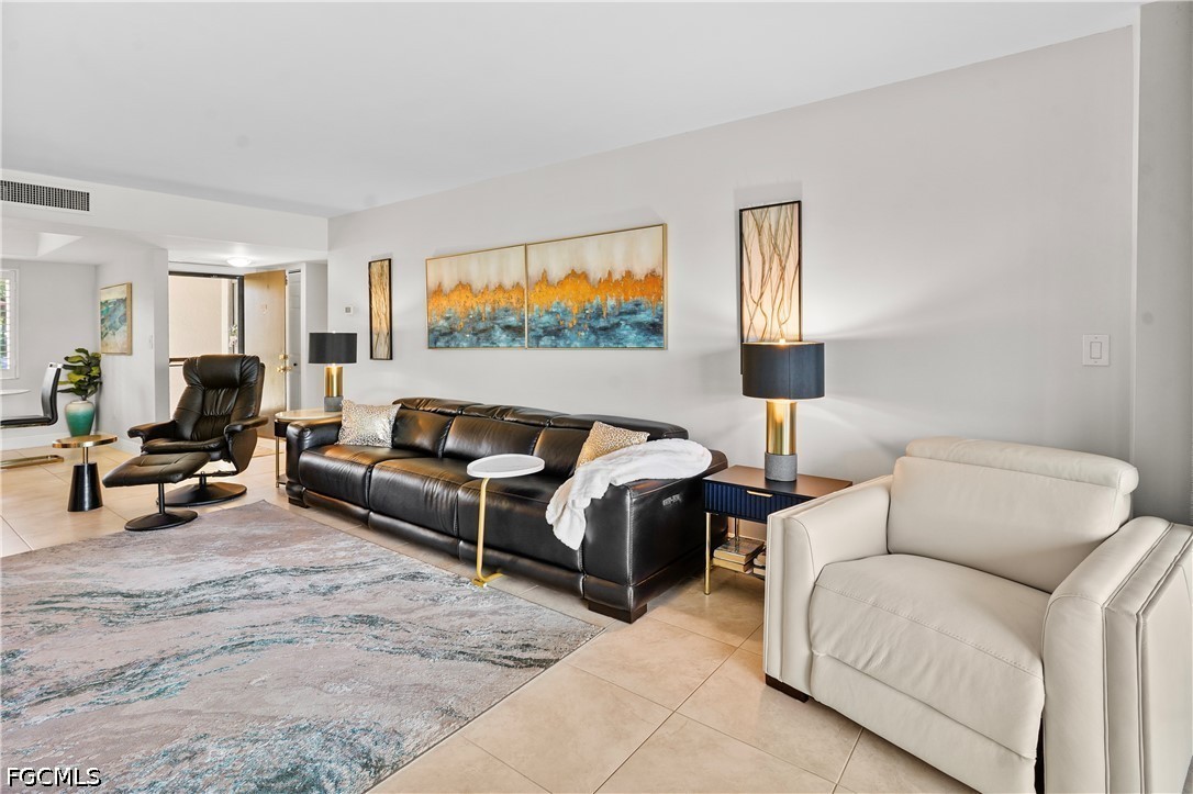 413 Augusta Boulevard, Unit 105 Naples, FL 34113 - Photo 14 of 45 a living room with furniture and a couch