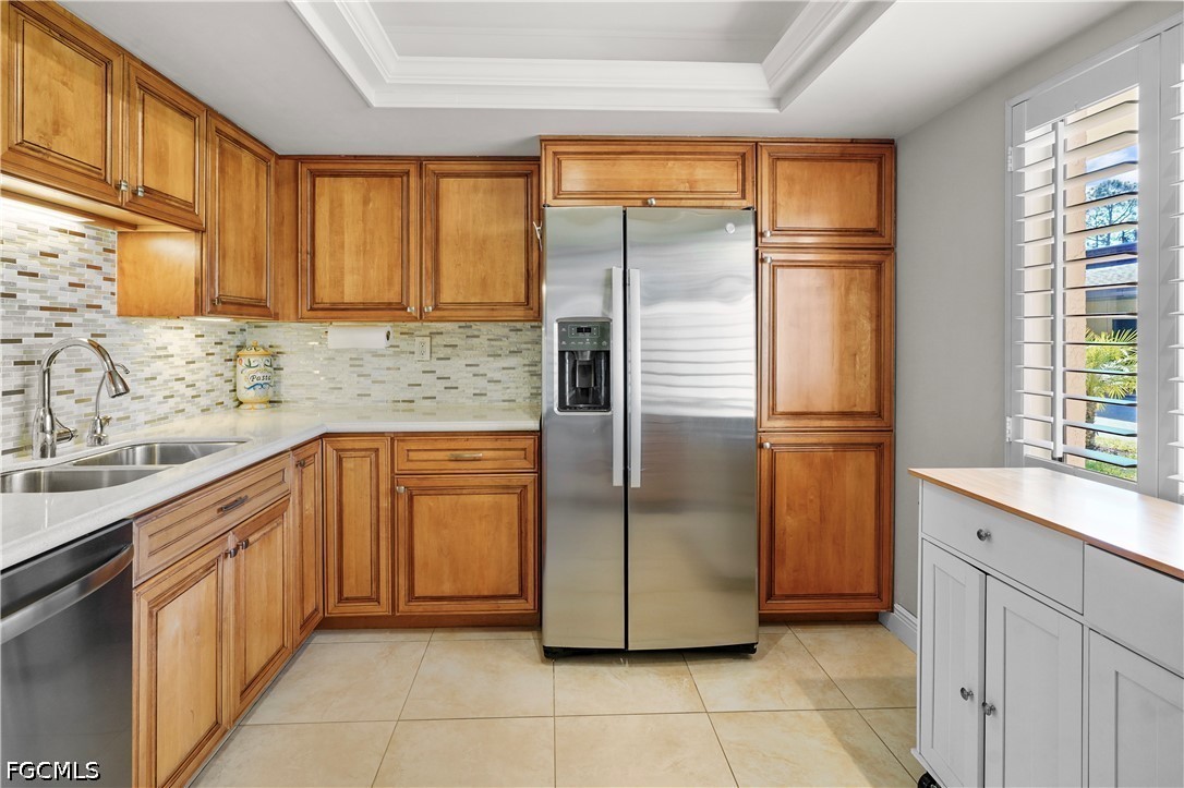 413 Augusta Boulevard, Unit 105 Naples, FL 34113 - Photo 15 of 45 a kitchen with stainless steel appliances granite countertop a refrigerator and a sink