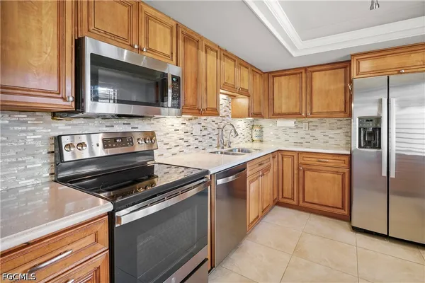 a kitchen with stainless steel appliances granite countertop a stove microwave and refrigerator