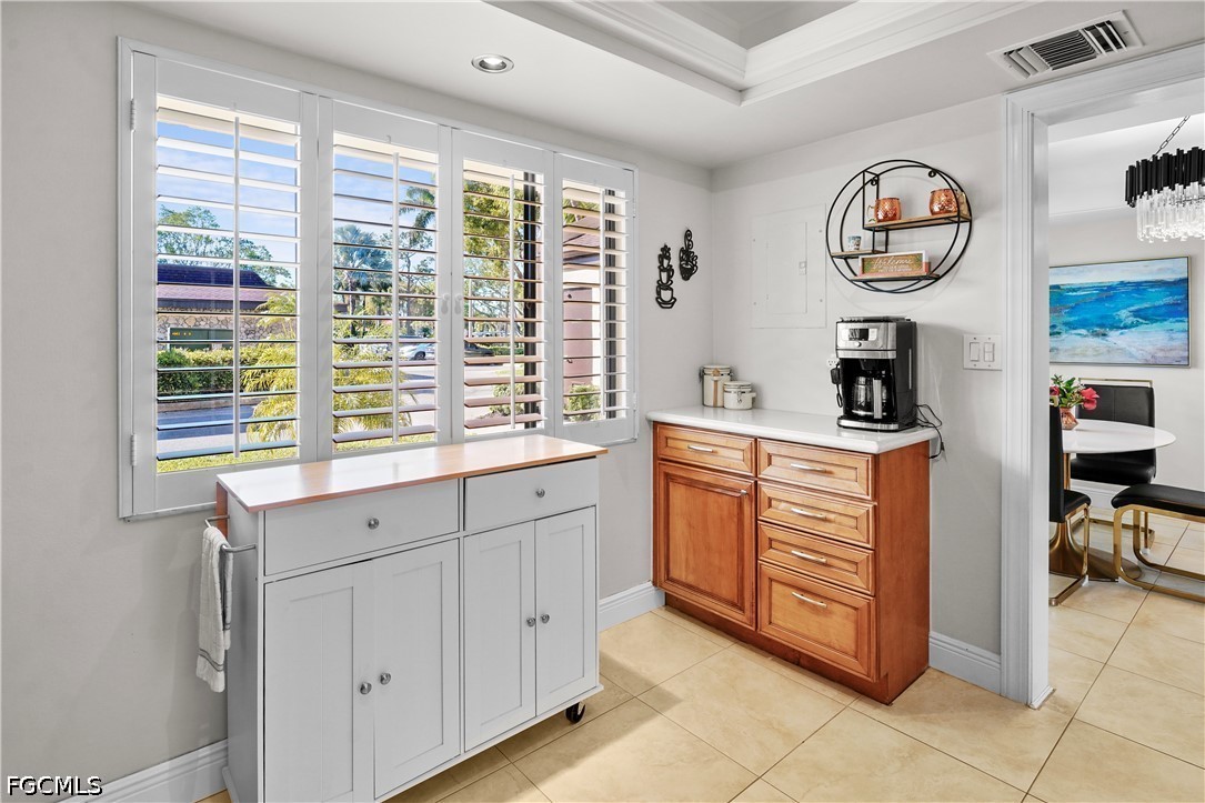 413 Augusta Boulevard, Unit 105 Naples, FL 34113 - Photo 17 of 45 a kitchen with appliances cabinets and a table