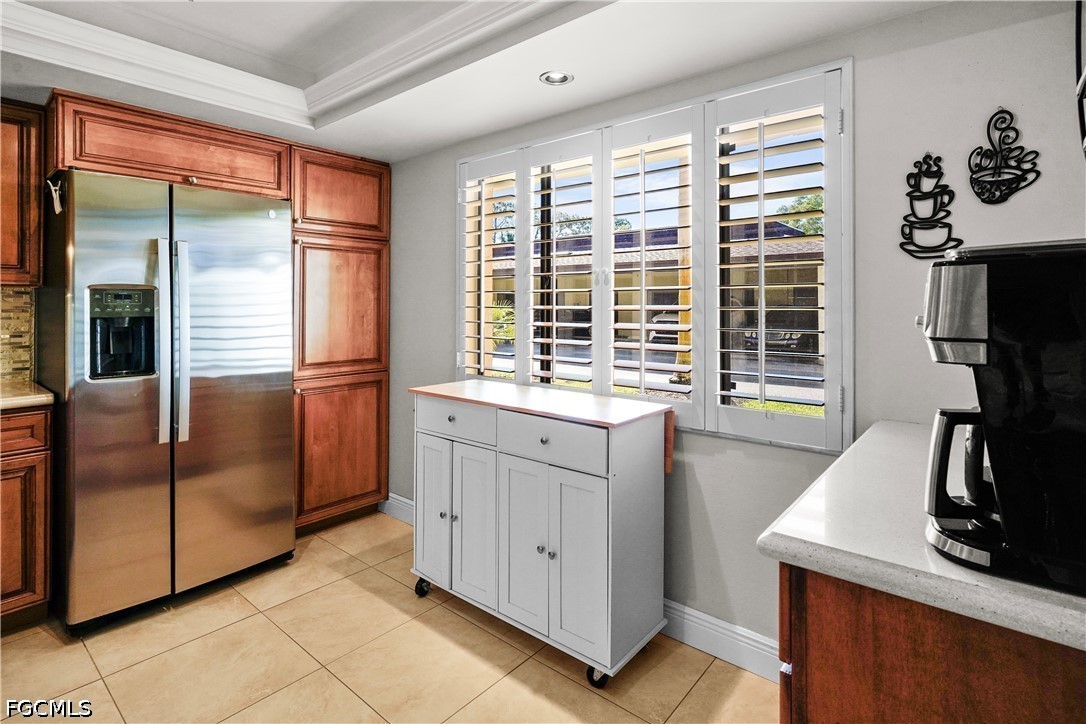 413 Augusta Boulevard, Unit 105 Naples, FL 34113 - Photo 19 of 45 a kitchen with granite countertop a refrigerator and a sink
