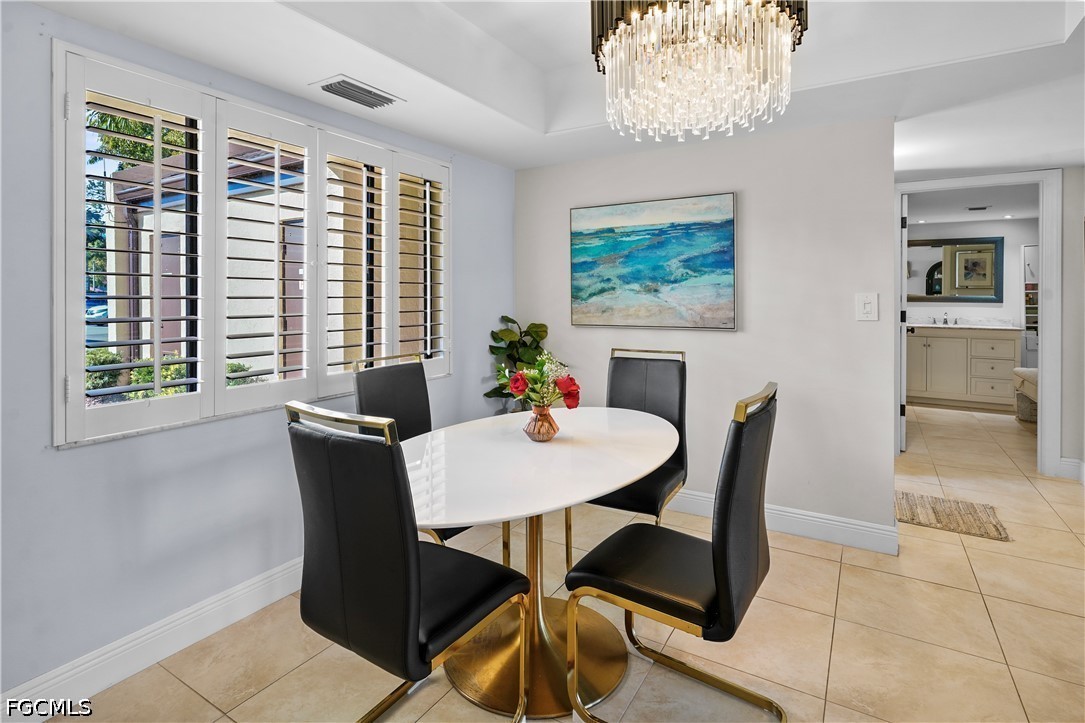 413 Augusta Boulevard, Unit 105 Naples, FL 34113 - Photo 20 of 45 a dining room with furniture and window