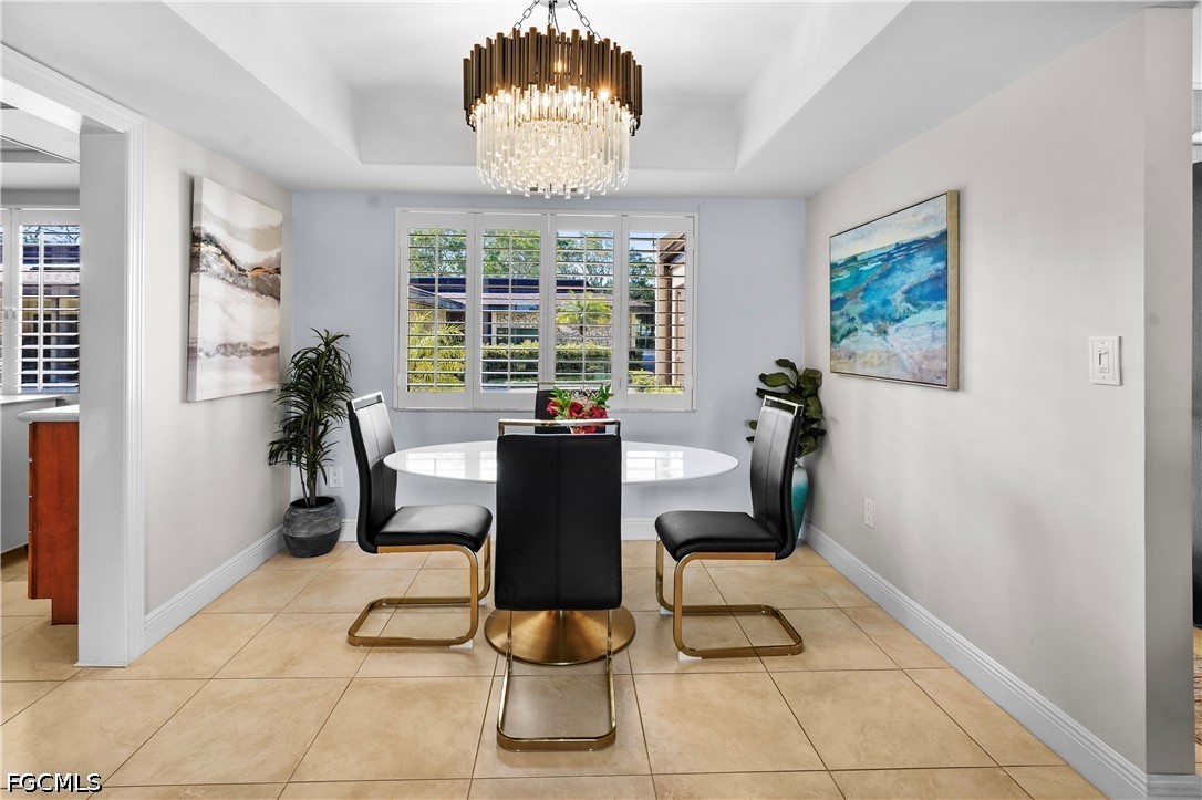 413 Augusta Boulevard, Unit 105 Naples, FL 34113 - Photo 21 of 45 a view of a dining room with furniture window and outside view