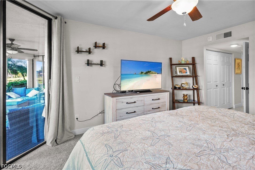 413 Augusta Boulevard, Unit 105 Naples, FL 34113 - Photo 25 of 45 a bedroom with a bed and a flat screen tv