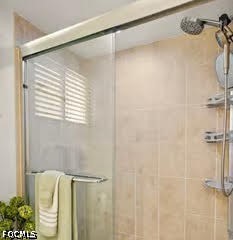 413 Augusta Boulevard, Unit 105 Naples, FL 34113 - Photo 29 of 45 a bathroom with a shower and a tub
