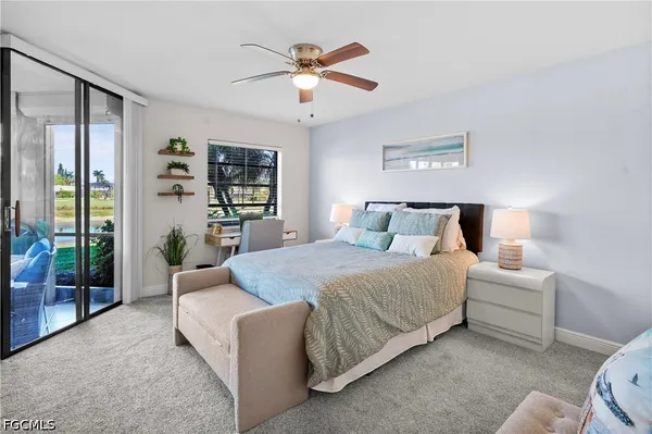 a bedroom with a large bed couch and a large window