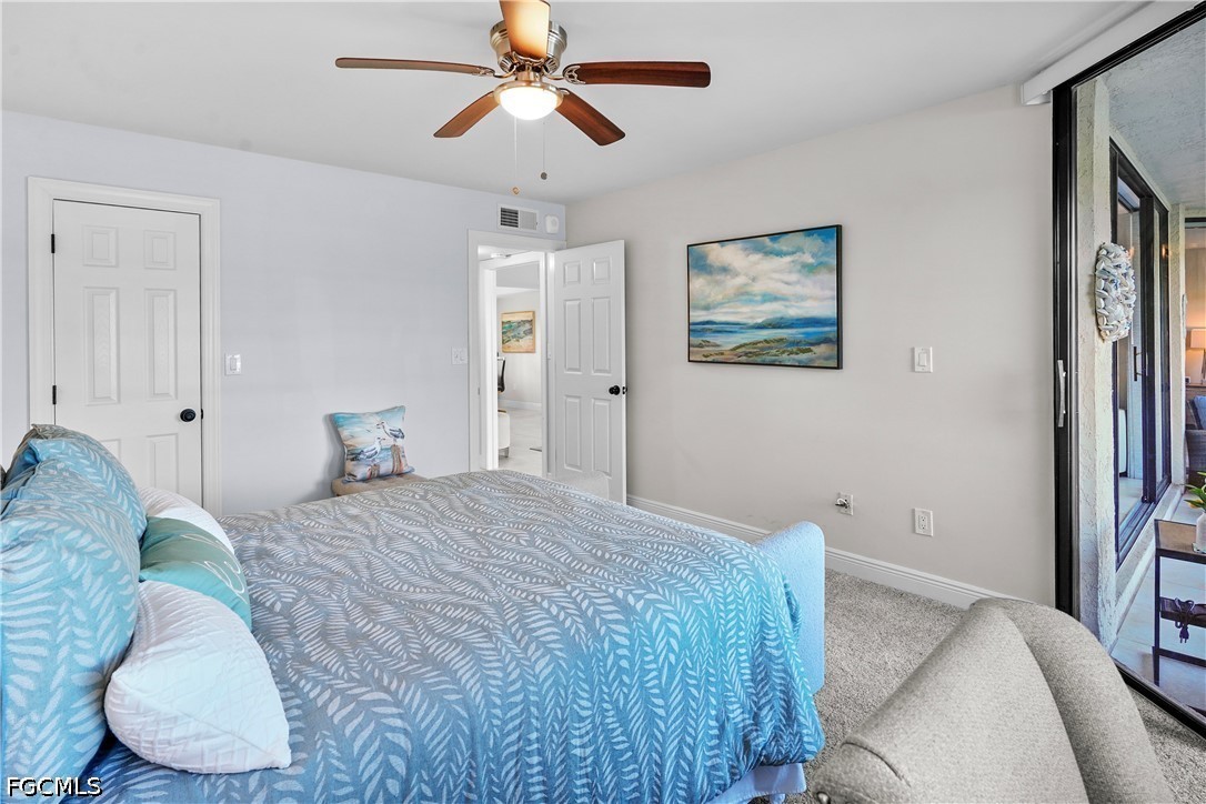 413 Augusta Boulevard, Unit 105 Naples, FL 34113 - Photo 34 of 45 a bedroom with a large bed and a chandelier