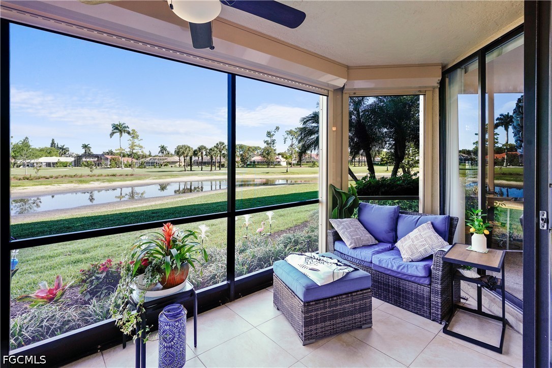 413 Augusta Boulevard, Unit 105 Naples, FL 34113 - Photo 38 of 45 a living room with couch and a floor to ceiling window