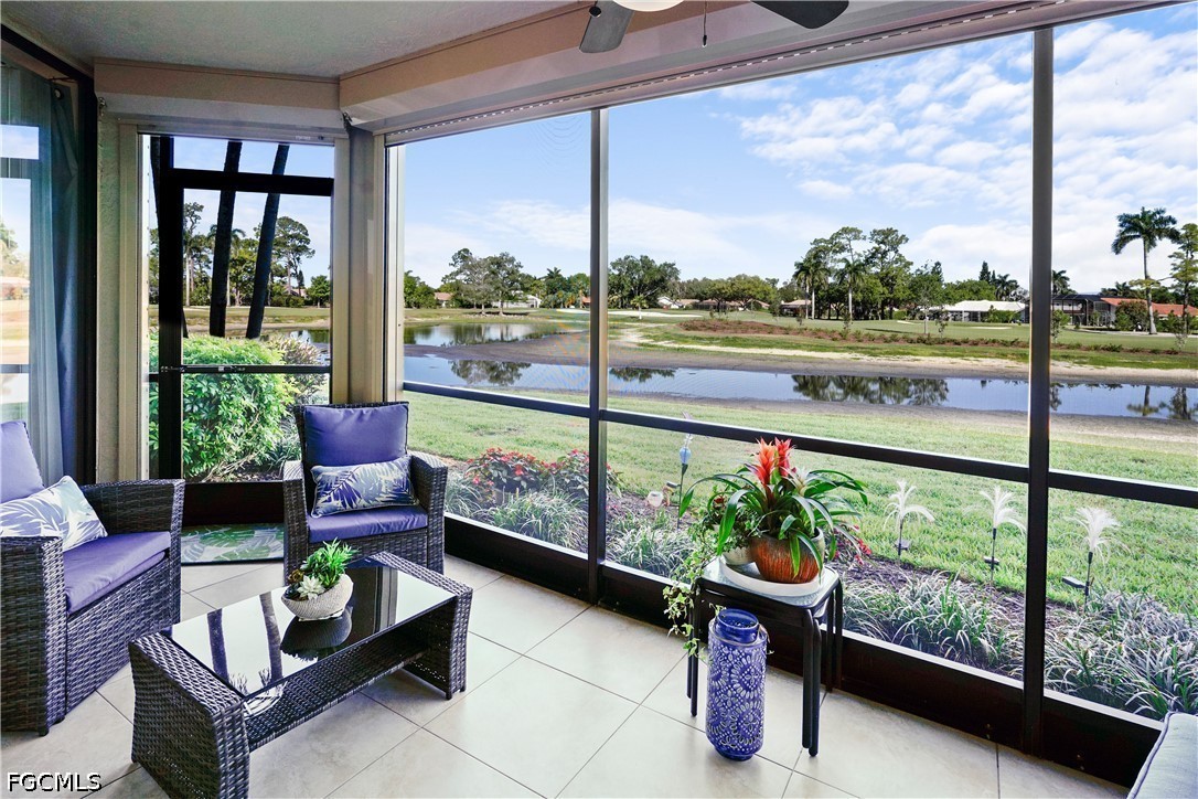 413 Augusta Boulevard, Unit 105 Naples, FL 34113 - Photo 39 of 45 a living room with glass windows and a table