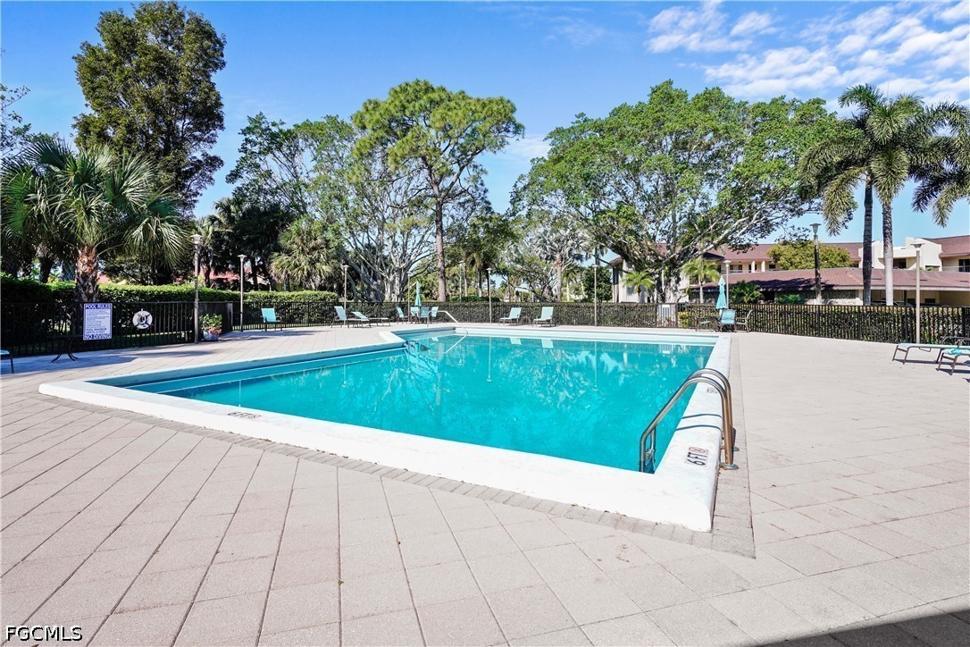 413 Augusta Boulevard, Unit 105 Naples, FL 34113 - Photo 41 of 45 a view of a swimming pool with a yard