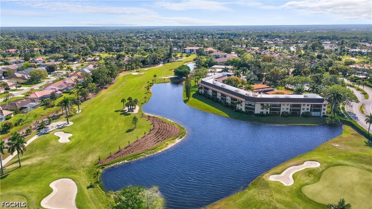413 Augusta Boulevard, Unit 105 Naples, FL 34113 - Photo 7 of 45 a view of a swimming pool with a lounge chair