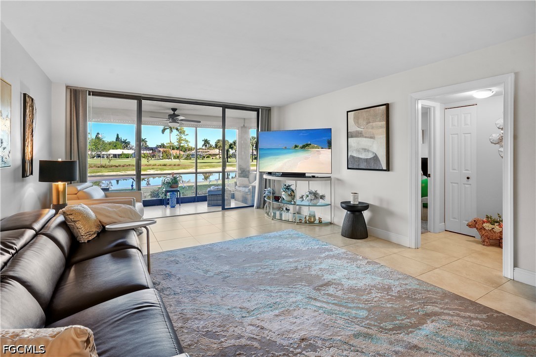 413 Augusta Boulevard, Unit 105 Naples, FL 34113 - Photo 9 of 45 a living room with furniture and a large window