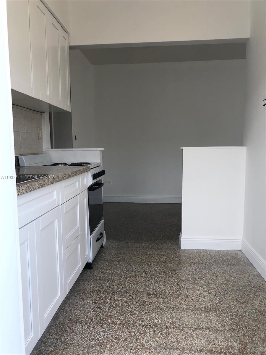 2830 Southwest 38th Court Miami, FL 33134 - Photo 4 of 6 a kitchen with a stove and a kitchen