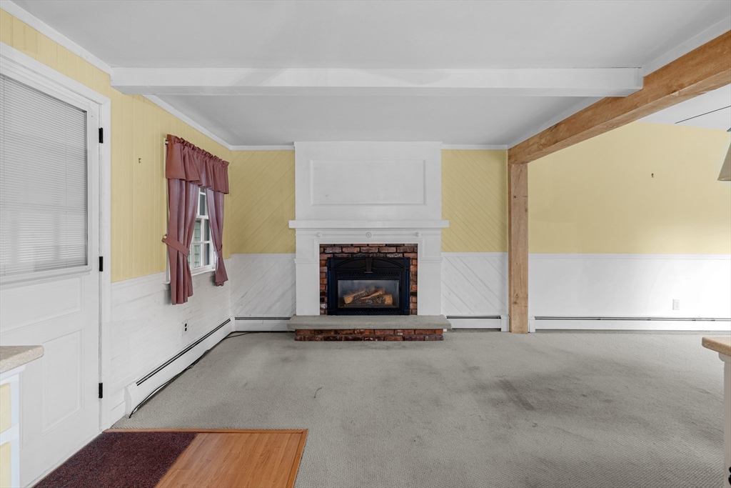 95 Brookside Road Somerset, MA 02726 - Photo 12 of 42 a living room with furniture and a fireplace