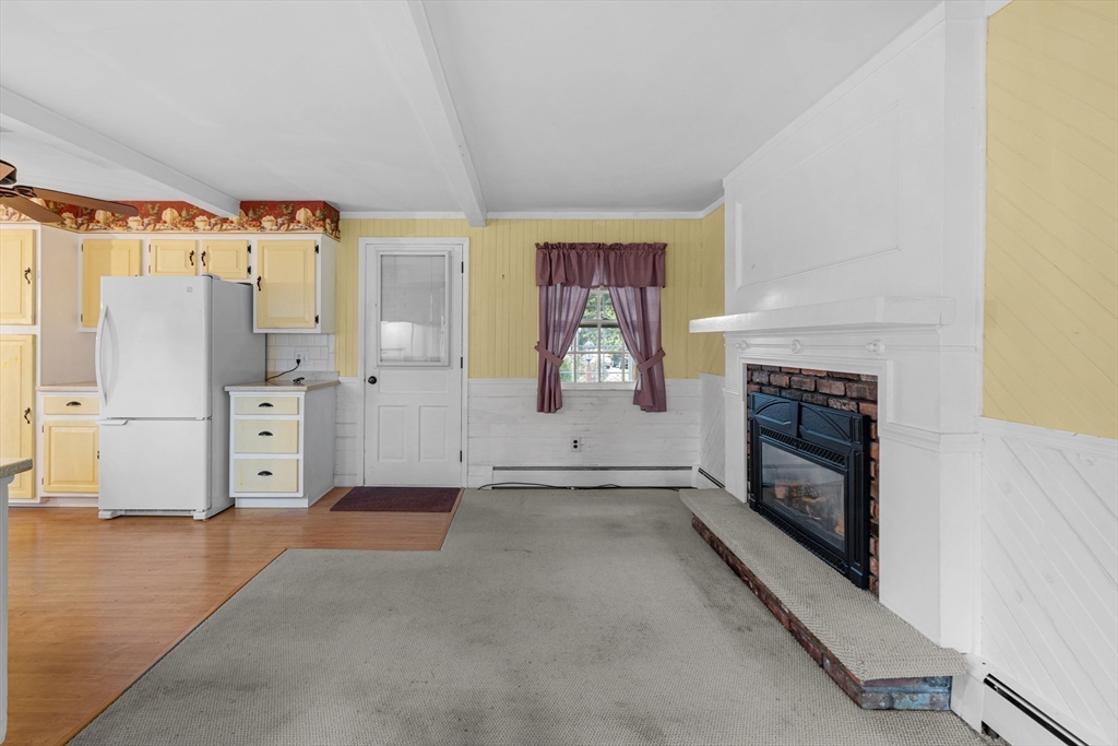 95 Brookside Road Somerset, MA 02726 - Photo 13 of 42 a view of kitchen with furniture and a fireplace