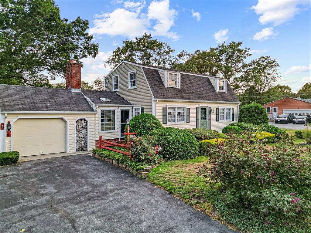 95 Brookside Road Somerset, MA 02726 - Photo 2 of 42 a front view of a house with a yard and garage