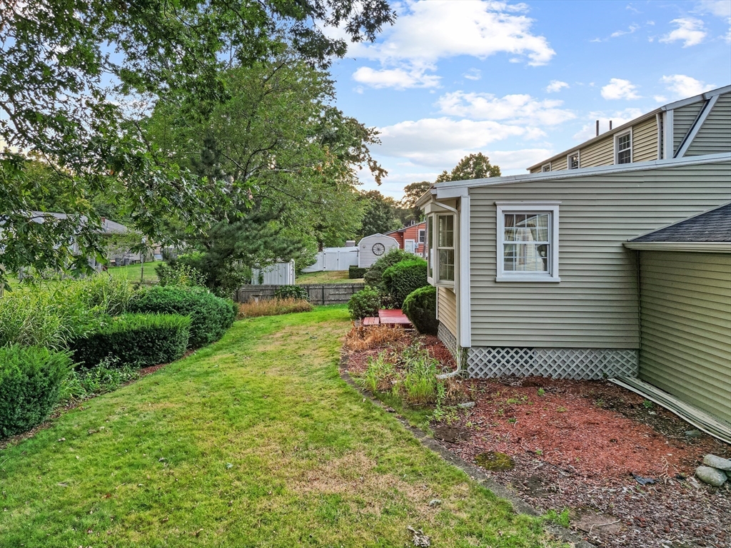 95 Brookside Road Somerset, MA 02726 - Photo 39 of 42 a backyard of a house with plants and tree
