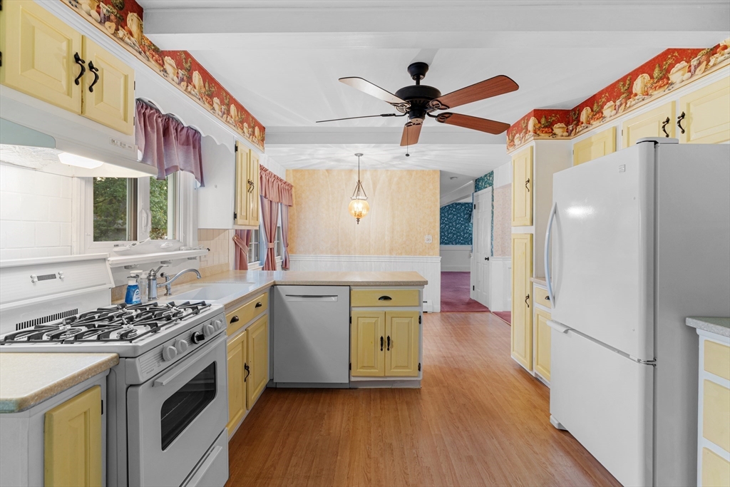 95 Brookside Road Somerset, MA 02726 - Photo 4 of 42 a kitchen with a stove a sink and a refrigerator