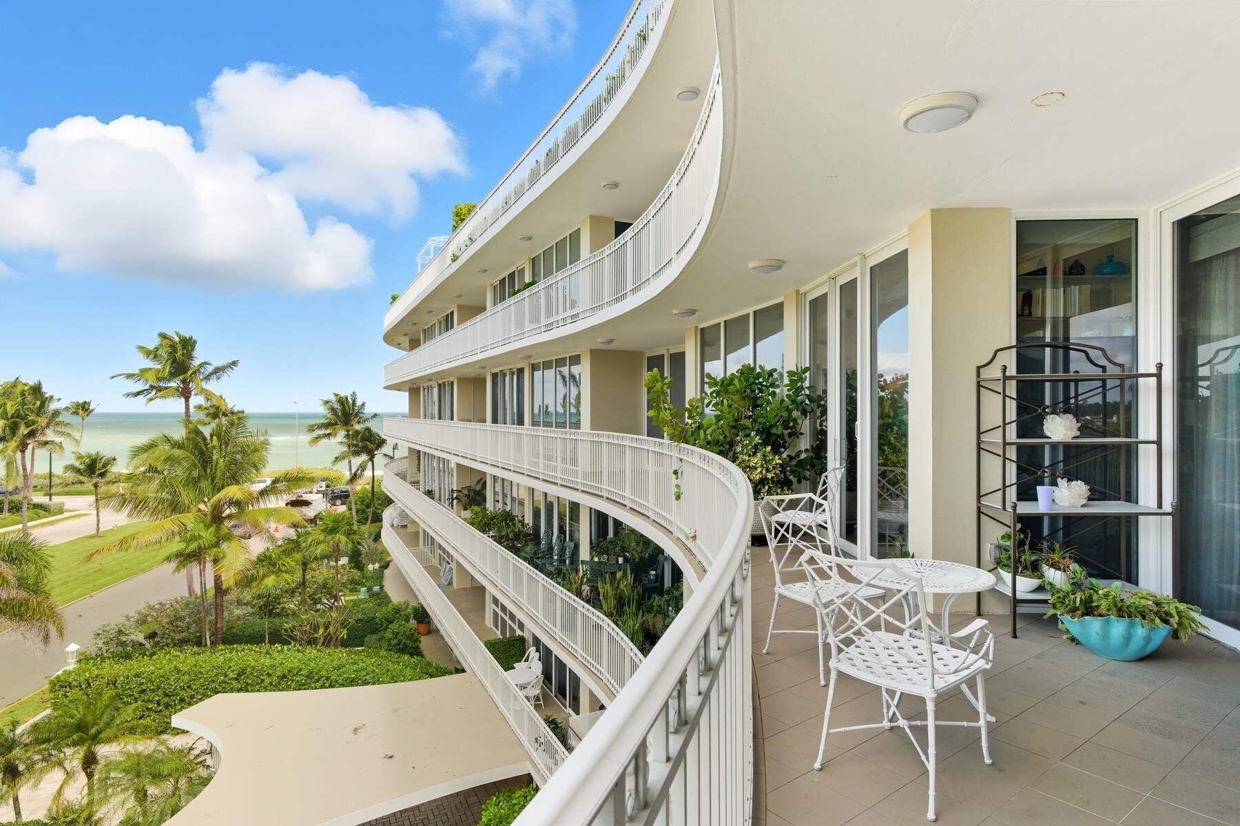 100 Royal Palm Way, Unit F4 Palm Beach, FL 33480 - Photo 1 of 28 a balcony with table and chairs