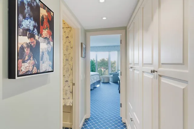 a view of a hallway with paintings on the wall