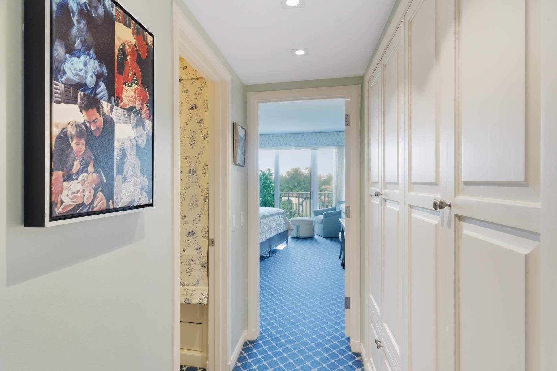 100 Royal Palm Way, Unit F4 Palm Beach, FL 33480 - Photo 11 of 28 a view of a hallway with paintings on the wall