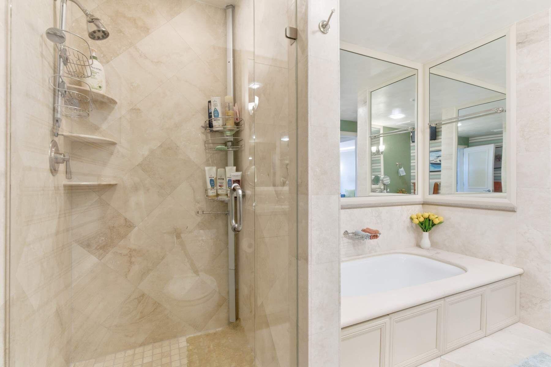 100 Royal Palm Way, Unit F4 Palm Beach, FL 33480 - Photo 16 of 28 a bathroom with a sink and shower