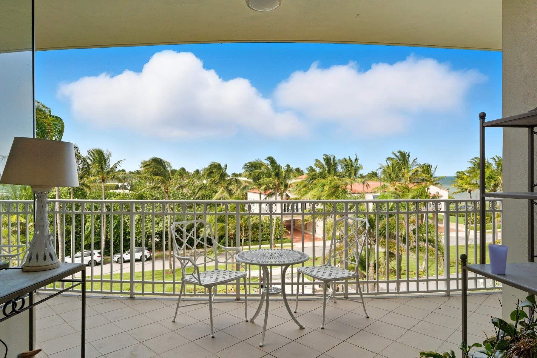 100 Royal Palm Way, Unit F4 Palm Beach, FL 33480 - Photo 2 of 28 a view of a lake with a table and chairs