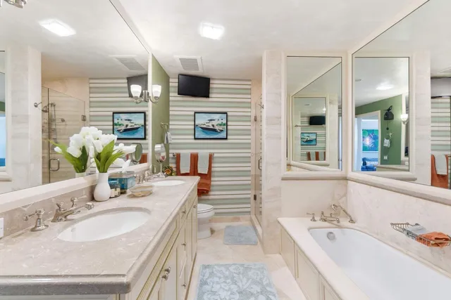 a bathroom with a granite countertop sink mirror and bathtub