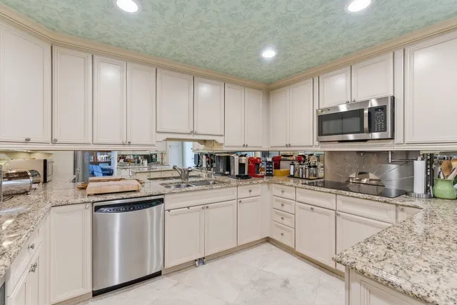 a kitchen with stainless steel appliances granite countertop a sink and cabinets