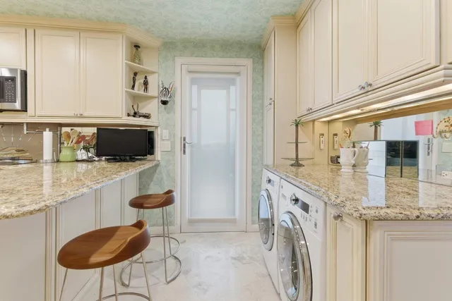 a kitchen with stainless steel appliances granite countertop a stove and a refrigerator