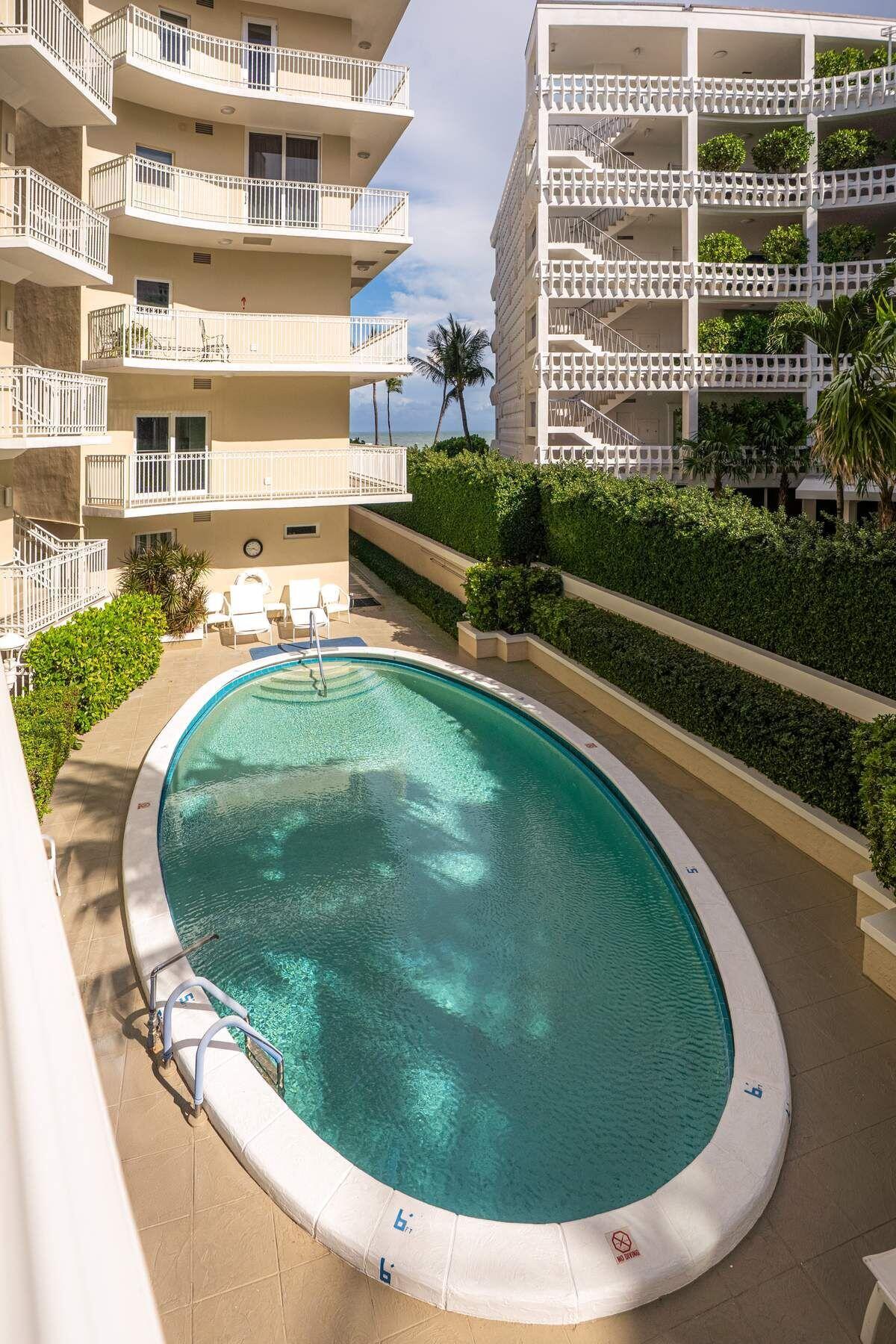 100 Royal Palm Way, Unit F4 Palm Beach, FL 33480 - Photo 28 of 28 a view of a swimming pool with a balcony
