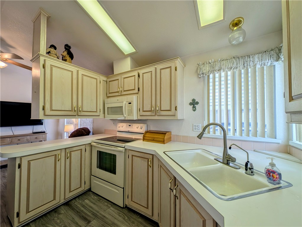 2000 Ramar Road, Unit 280 Bullhead City, AZ 86442 - Photo 20 of 63 a kitchen with a sink stove and cabinets