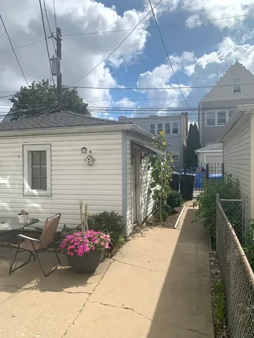 a view of a chairs and table in backyard