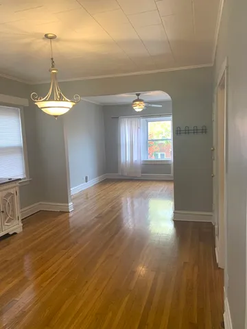 a view of a room with wooden floor and window