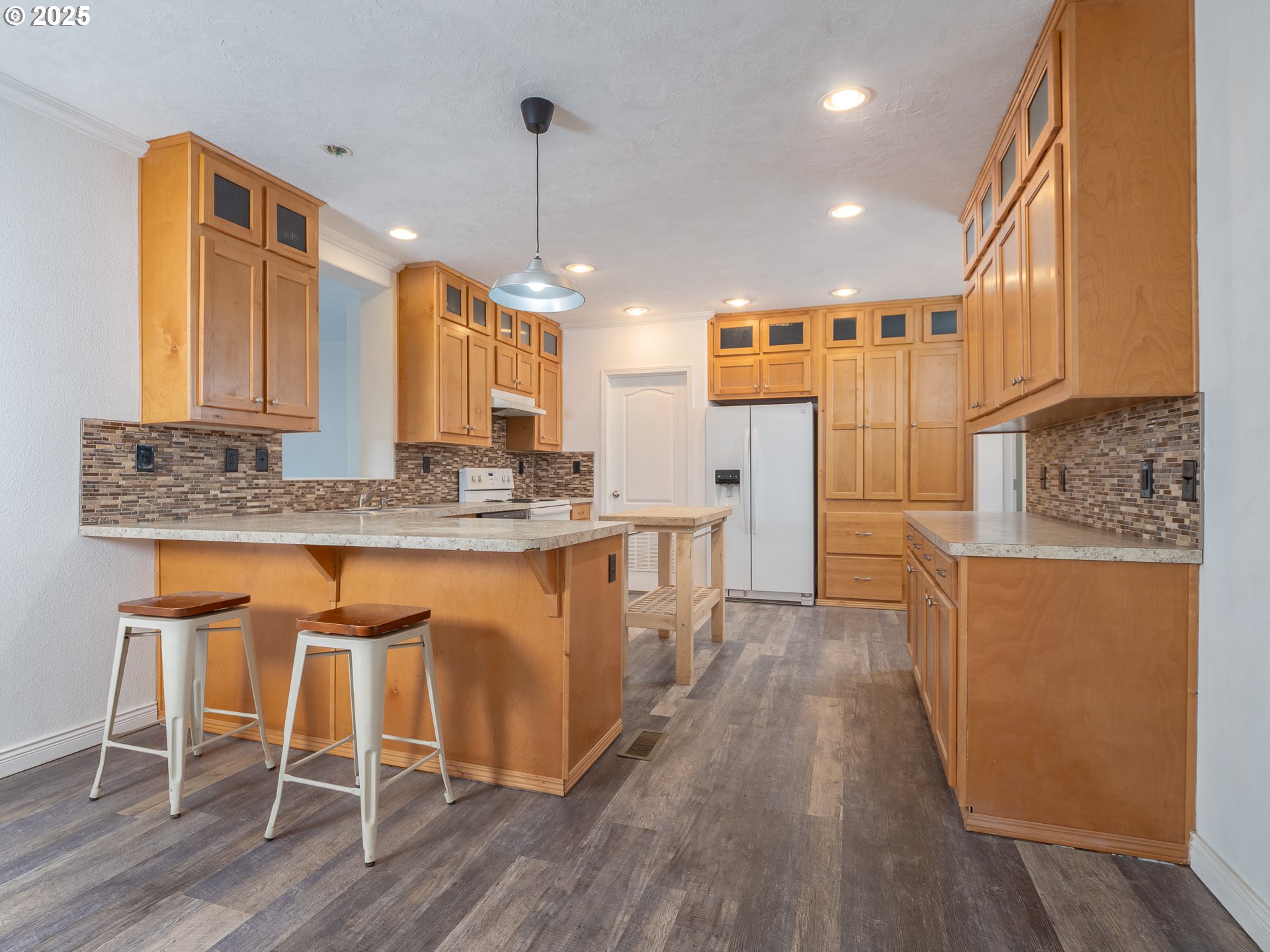 44300 Southeast Sandercock Lane Sandy, OR 97055 - Photo 13 of 48 a kitchen with stainless steel appliances granite countertop wooden floor sink and cabinets