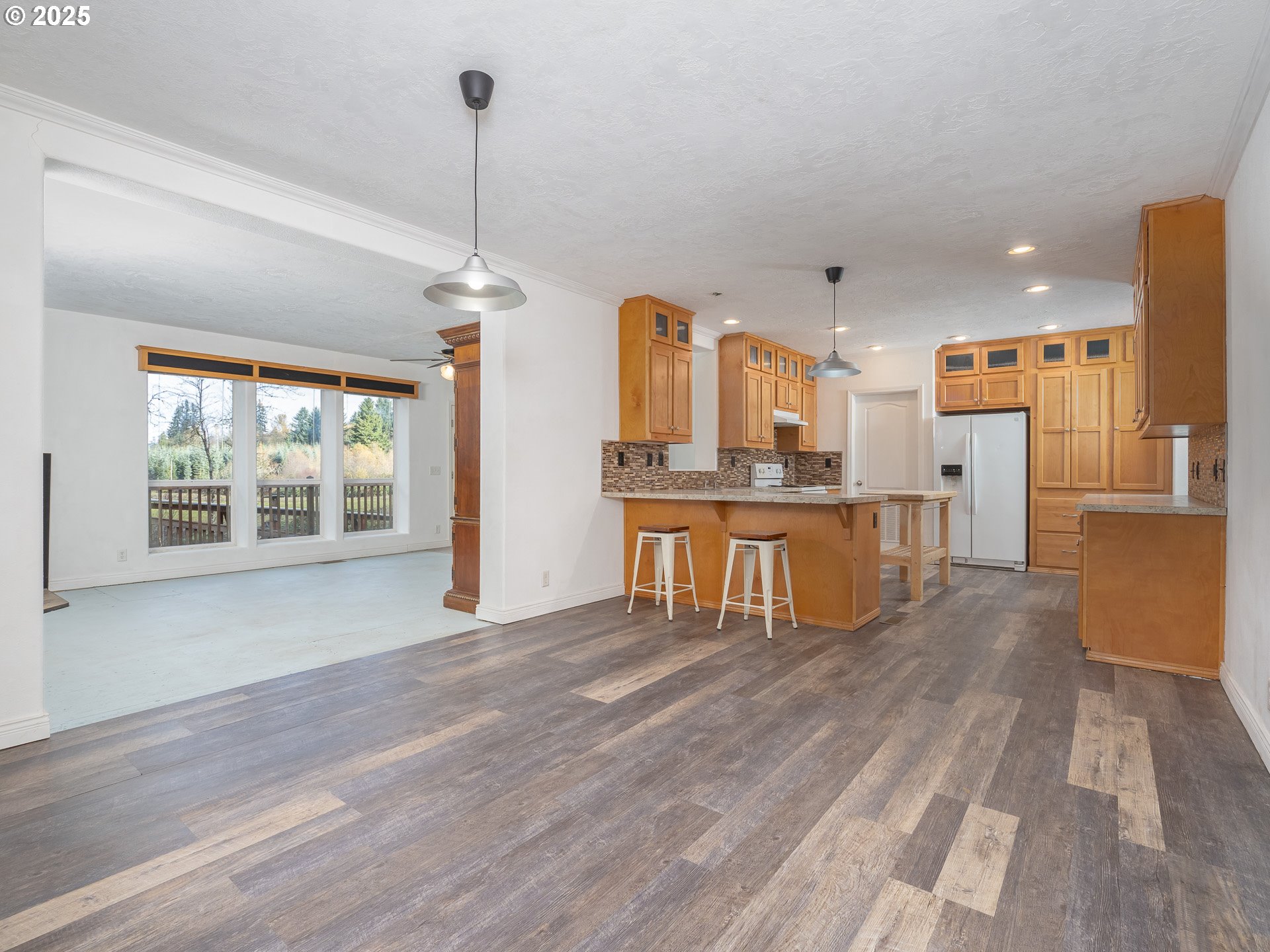 44300 Southeast Sandercock Lane Sandy, OR 97055 - Photo 17 of 48 a view of a kitchen with stainless steel appliances wooden floor and a large window